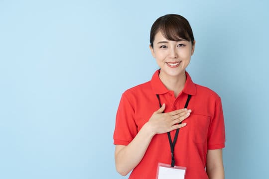 portrait of young asian woman wearing red polo shirts on blue background